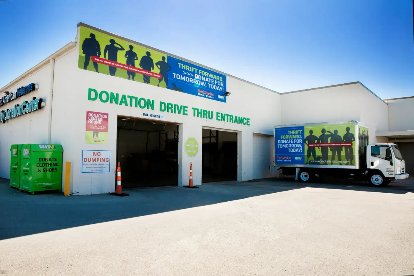 Donated bags and boxes being handed off at a Red Racks drive-thru donation lane
